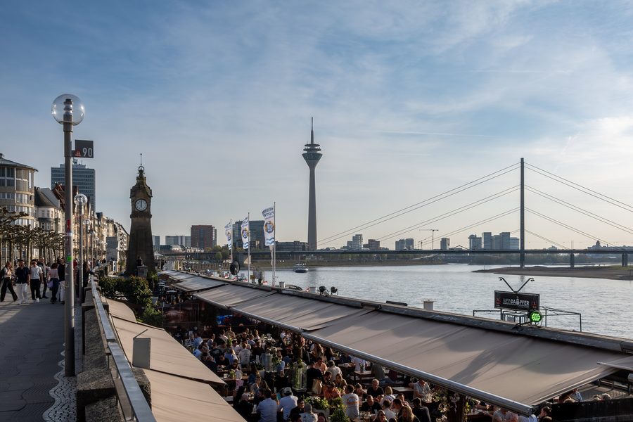 Rhine promenade in Düsseldorf with the Rhine Tower and Rhine knee bridge in the background