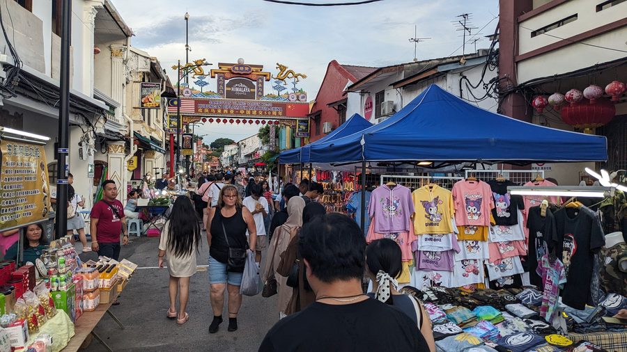 Crowded Jonker Street Night Market in Melaka with stalls and shoppers after dark.