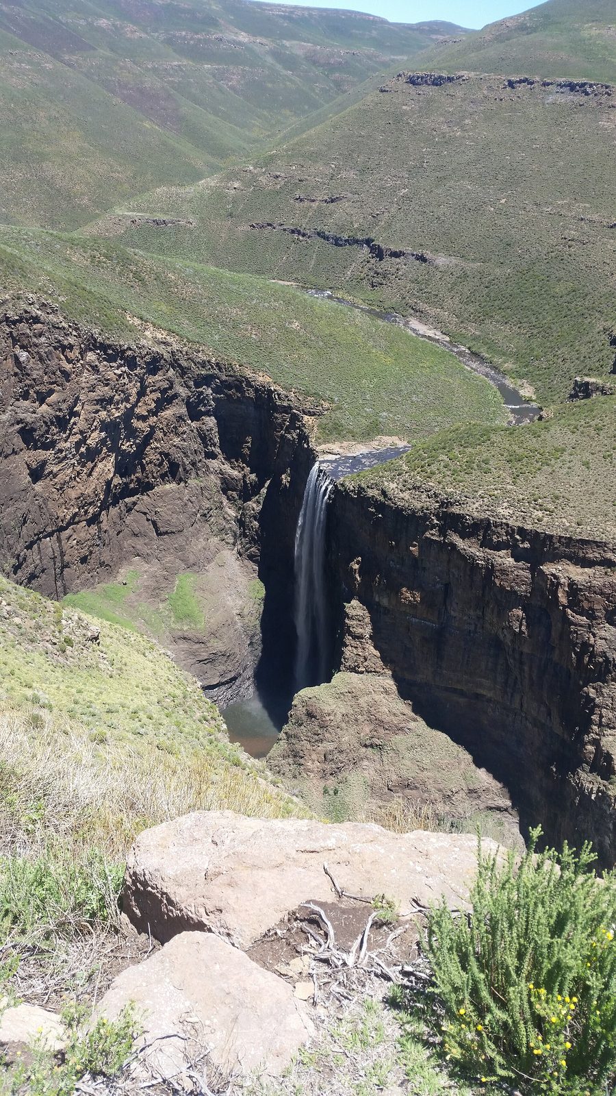 Waterfalls and steep mountains in the Lesotho Highlands.