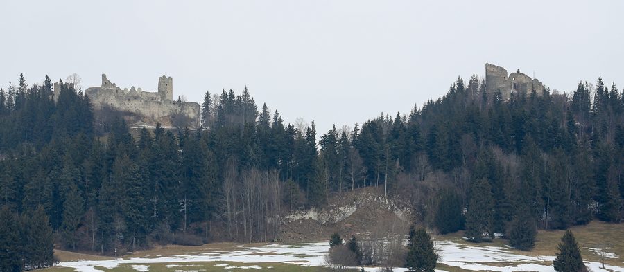 Die gegenüberliegenden Burgruinen Eisenberg und Hohenfreyberg auf bewaldeten Hügeln im Ostallgäu