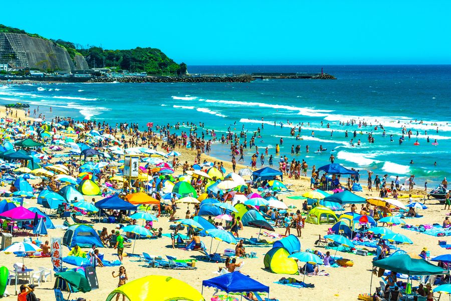 Visitors and colorful sunshades at Onjuku Beach in Chiba, Japan