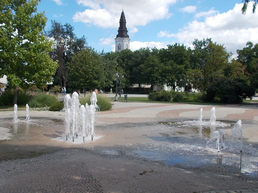 Fountain and Reformed church tower on Kossuth Square in Kecskemét.