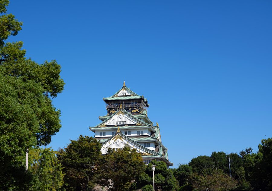 Osaka Castle surrounded by stone walls and parkland.