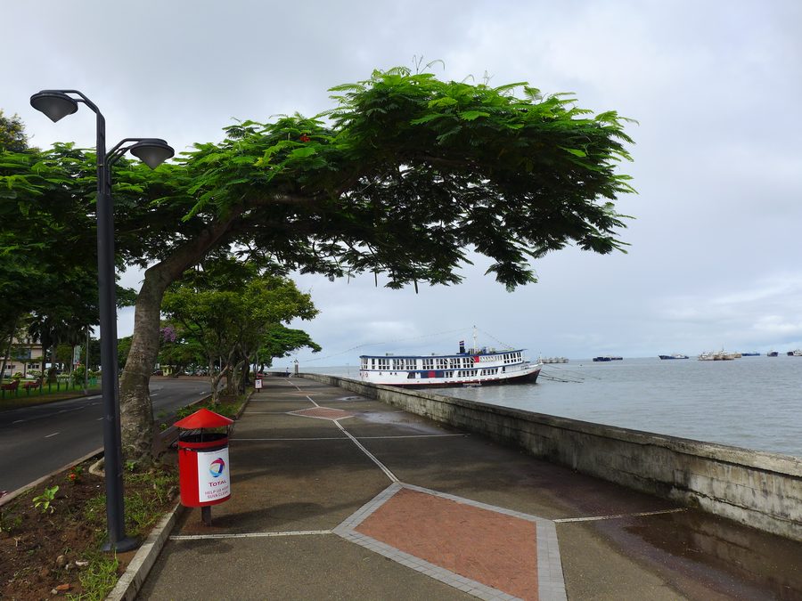 Suva waterfront promenade with anchored ships in the harbor.