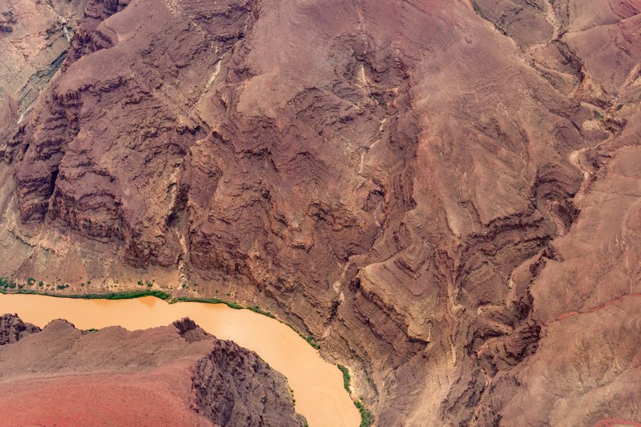 Aerial view of the Grand Canyon in Arizona with the Colorado River winding through the gorge.