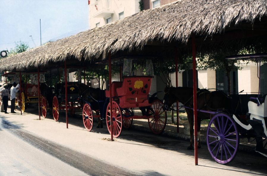 Downtown Nassau near Rawson Square with a taxi stand and historic city buildings.