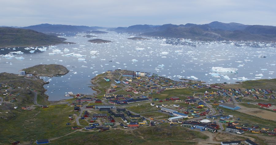Narsaq seen from Qaaqarsuaq mountain with surrounding mountains and coast.