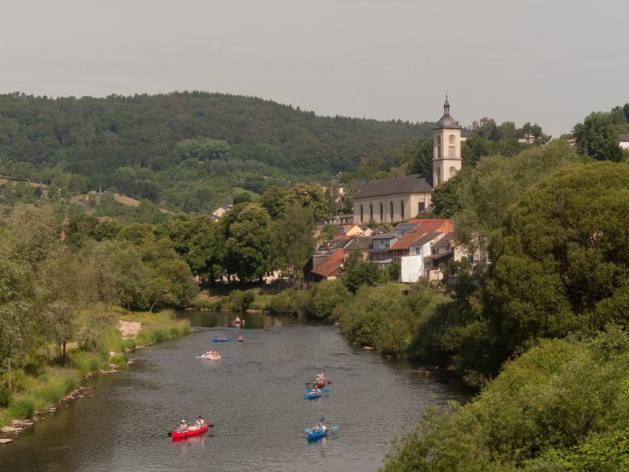 The Sauer river in Bollendorf with St. Michael parish church in the background