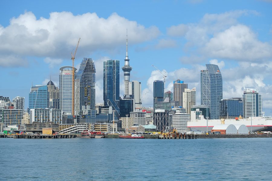 Auckland CBD skyline with the Sky Tower beside Waitematā Harbour.