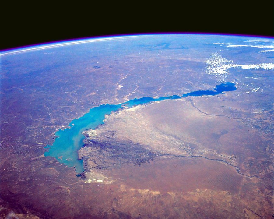 A high-oblique view of Lake Balkhash’s turquoise water and shoreline.