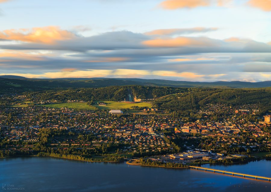 Una veduta di Lillehammer con edifici raccolti lungo la valle e le colline circostanti.