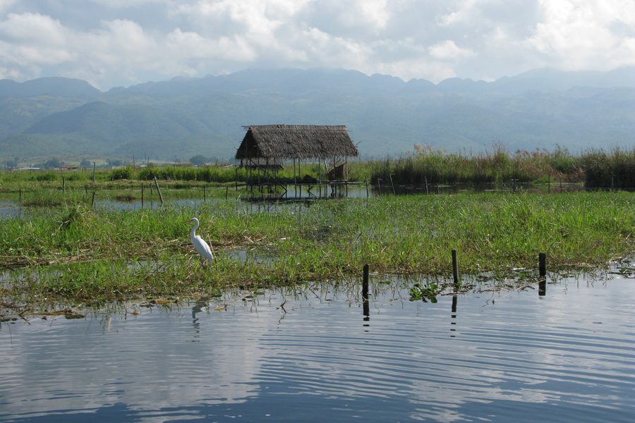 Stilted house on the calm waters of Inle Lake in Shan State, Myanmar.