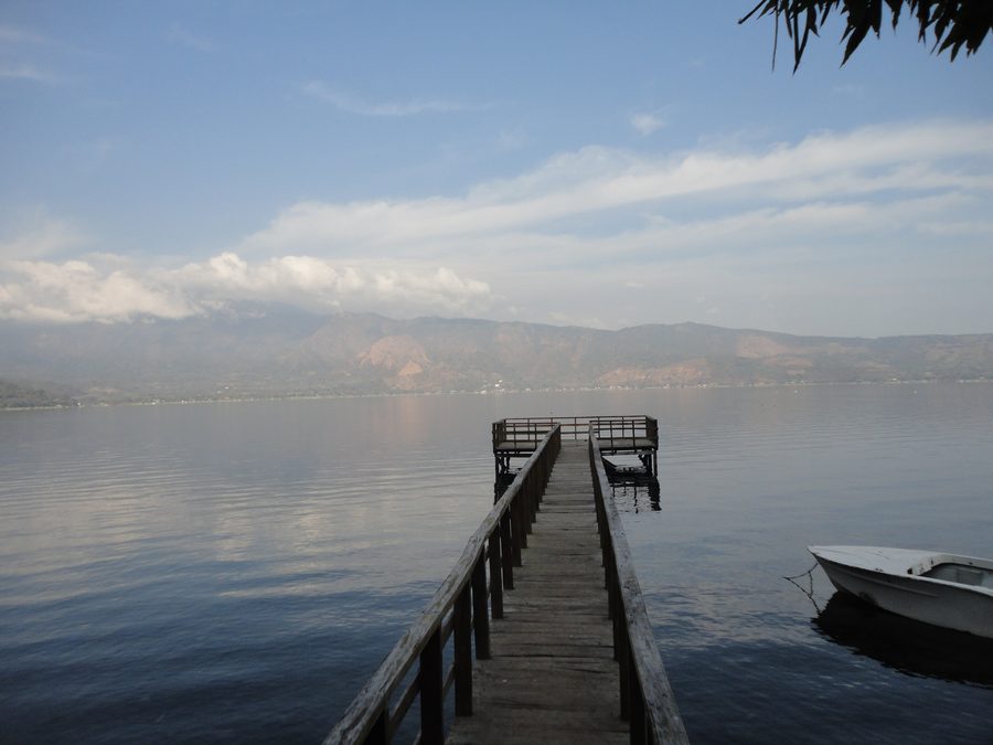 Lago de Coatepeque at dawn with volcanic hills in western El Salvador.