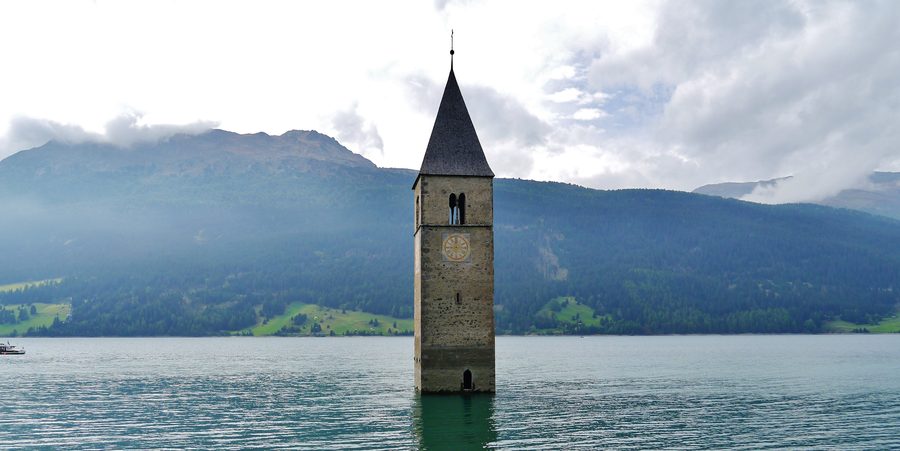 Church Tower of Old Graun rising from Reschen Lake at Reschenpass in South Tyrol